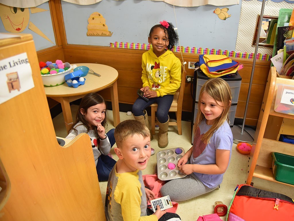 Image of 4 young children in a classroom
