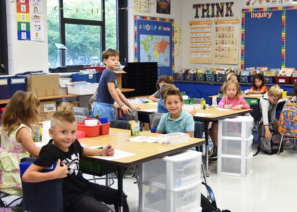 Image of young students sitting at their desks in a classroom on the first day of school at Cassingham Elementary
