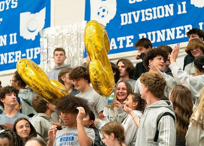 Image of a large group of high school students having fun in the bleachers during a school event